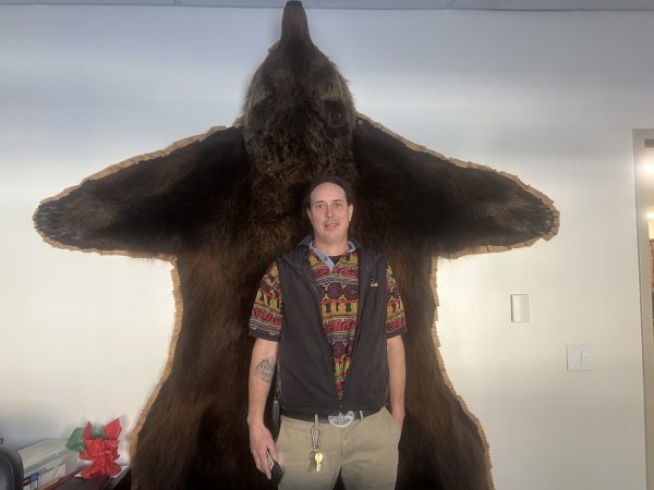 Mr. McMurray in front of a large bear donated by Fish & Game, AK 