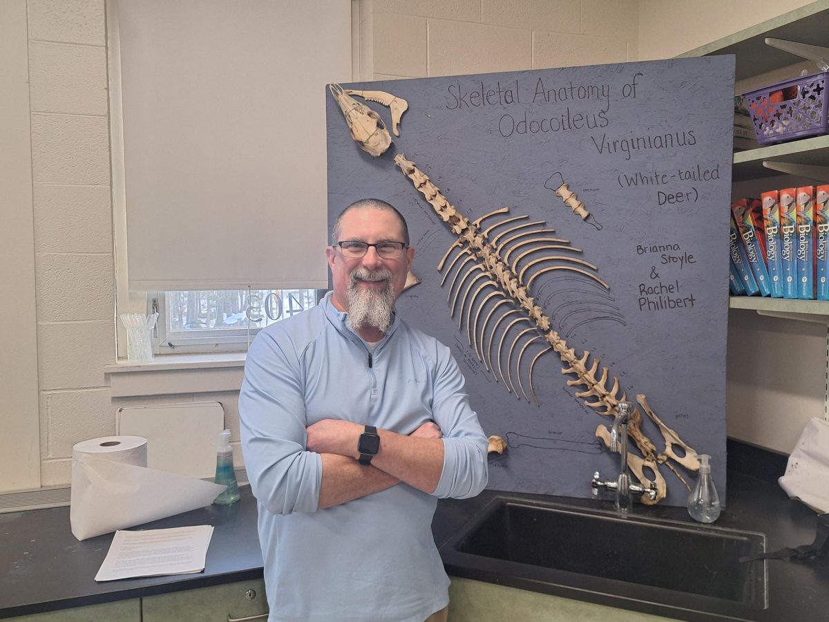 Mr. Lambert in front of his skeleton of a white tail deer.