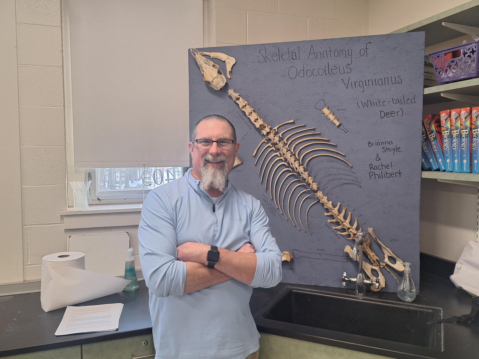 Mr. Lambert in front of his skeleton of a white tail deer.